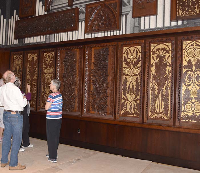 Guests taking in the art-carved panel display