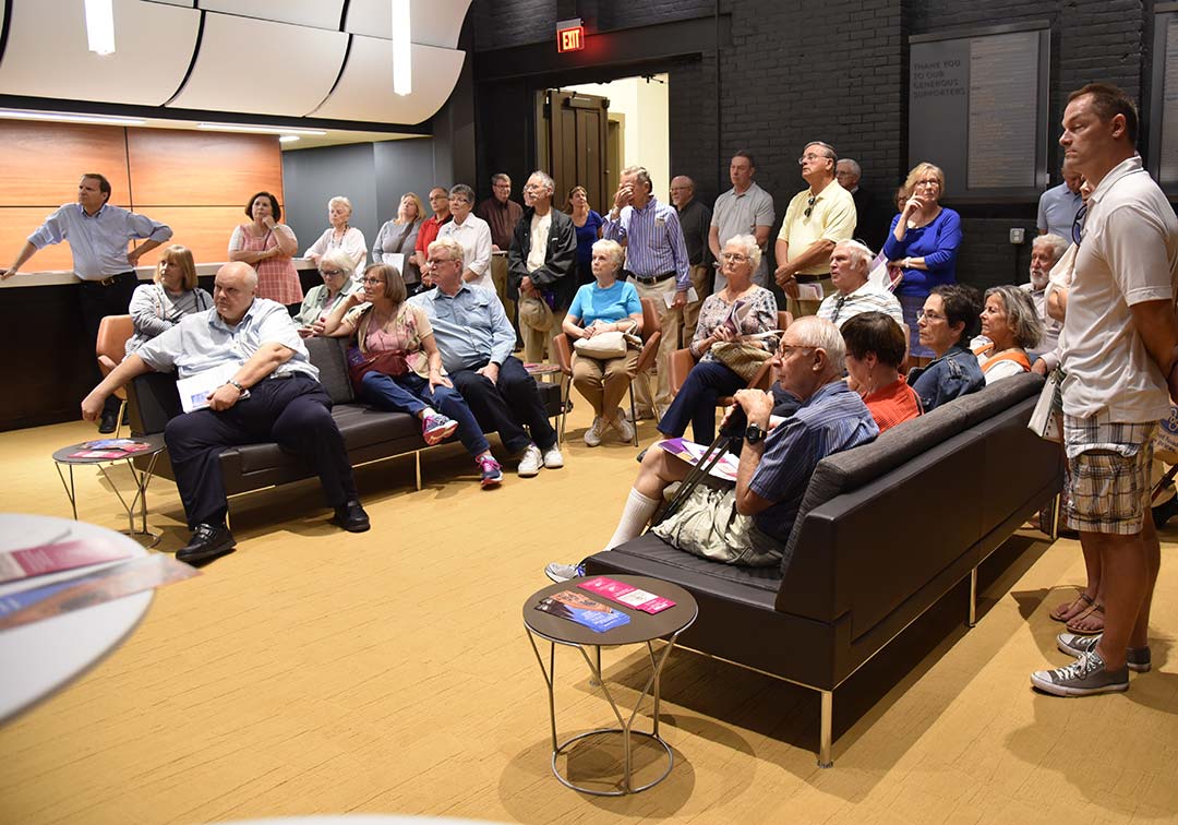 Visitors to the Taft Suite watch a presentation on the art-carved panels.