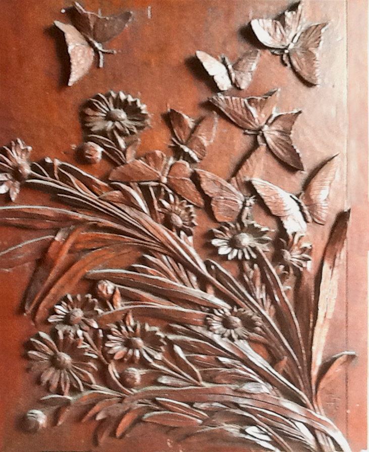 The art-carved panel titled "Noon"