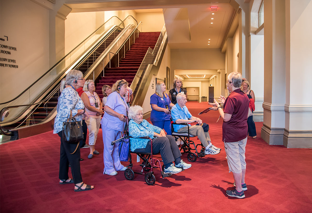 Sue Monteith entertaining the Macks and their team with stories about Music Hall's history