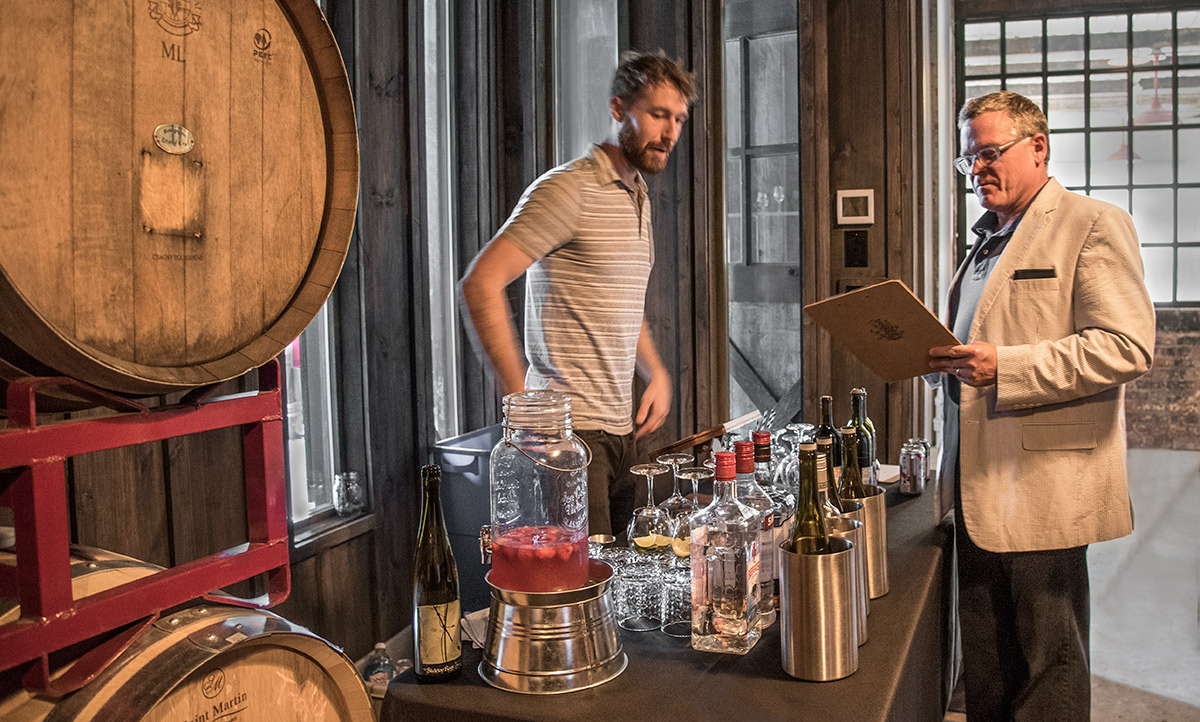 John Morris Russell at the wine table, reviewing the wine list