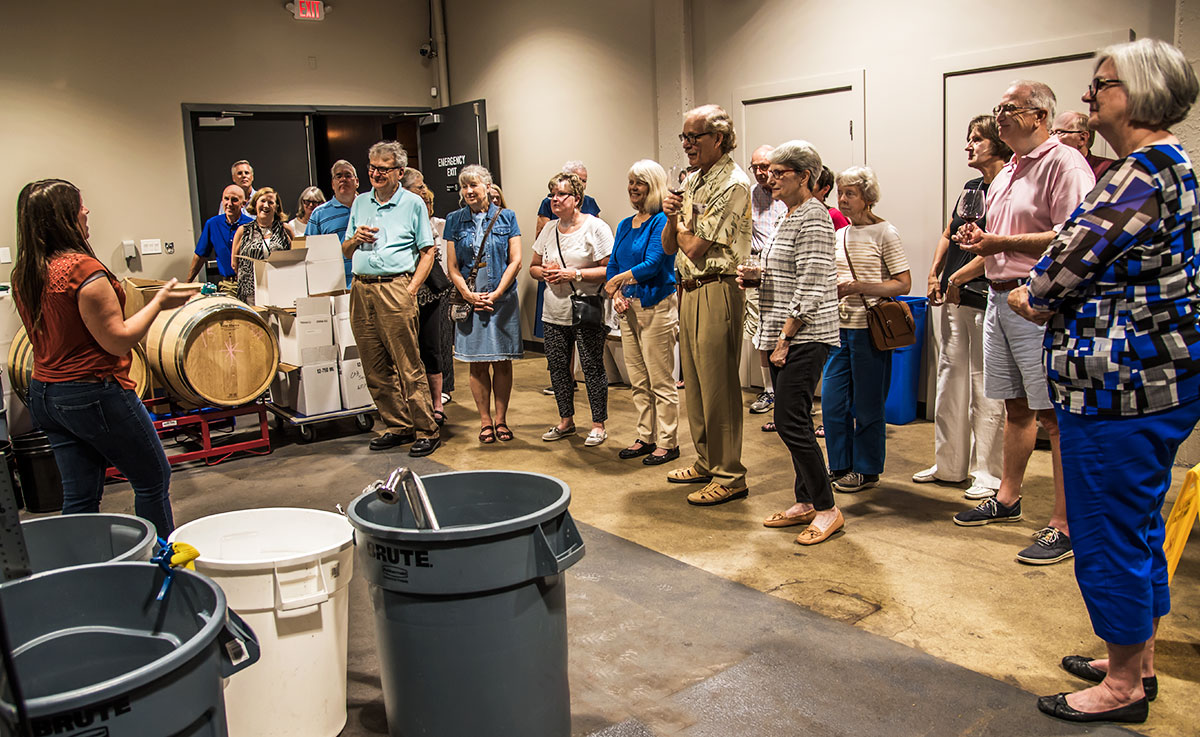 Volunteers surveyed the production room while Kate talked about the process.