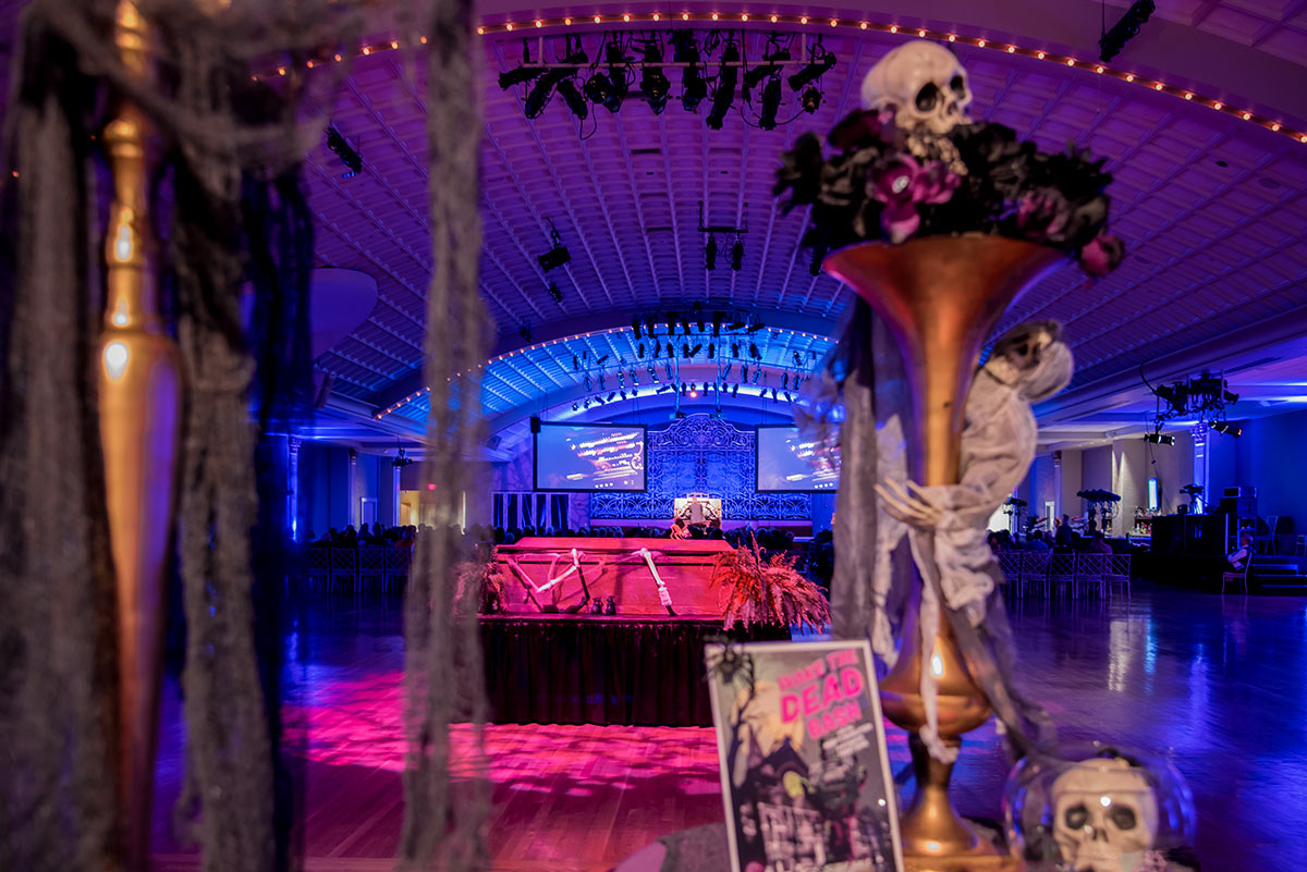 Trent Sims at the keyboard with Halloween decorations throughout the hall