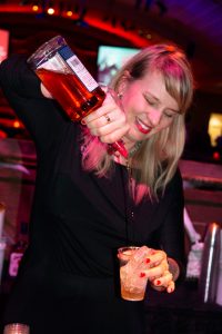 Molly Wellmann mixing drinks for Bash guests