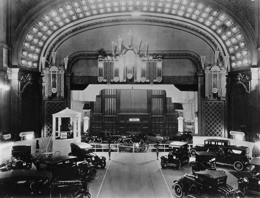 Photo showing a temporary floor in Music Hall auditorium on which cars were displayed