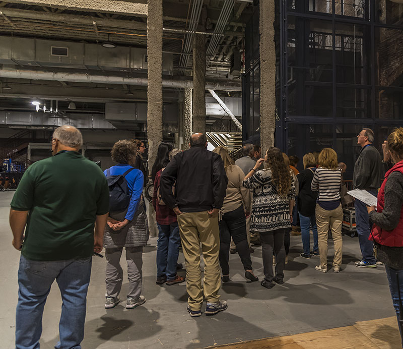Ghost Tour guests walk through the shop backstage, in the area that at one time held exhibits in the North Hall.