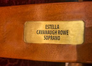 “Estella Cavanaugh Rowe” brass plaque on orchestra right, row N, seat 302