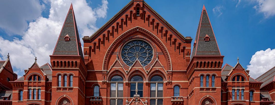 Cincinnati Music Hall showing four restored fnials and, in the center, restored spikes on the lyre above the date stone
