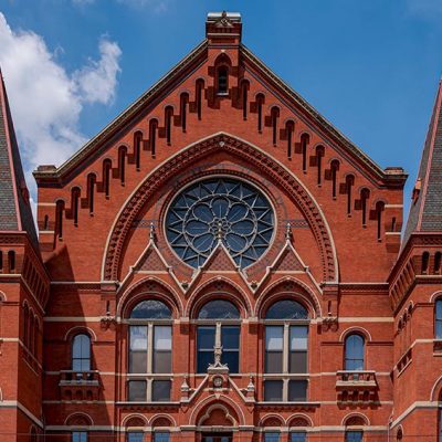 Cincinnati Music Hall showing four restored fnials and, in the center, restored spikes on the lyre above the date stone