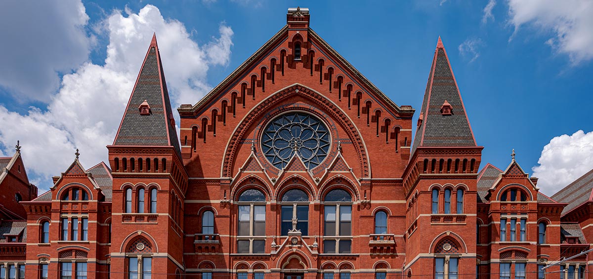 Cincinnati Music Hall showing four restored fnials and, in the center, restored spikes on the lyre above the date stone