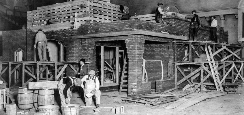 Laborers in the north hall of Music Hall, building the model home.