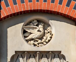 Photo of a stone medallion with a bird singing