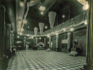 Photo of the main foyer of Music Hall, looking south, decorated for an exposition, circa 1928