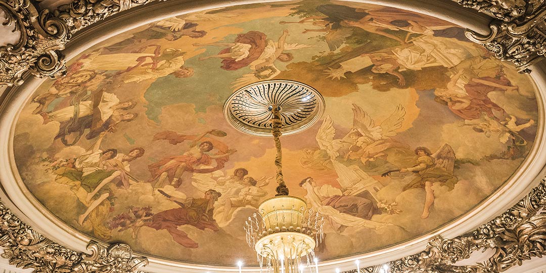 A photo of the Allegory of the Arts mural in the ceiling of Music Hall