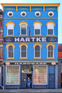 Today Hartke Hardware,Tom Hartke in Doorway.