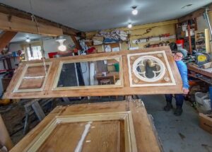 Adele Johnson holding up interior side of door with trim installed