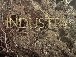The word "INDUSTRY" in gilt on the back of the pedestal of the statue of Reuben R. Springer in Cincinnati Music Hall.
