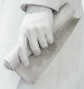 Scroll of Architectural Drawing of East Façade Music Hall in Left Hand of Reuben Springer (1882) Statue by Preston Powers, Cincinnati Music Hall.